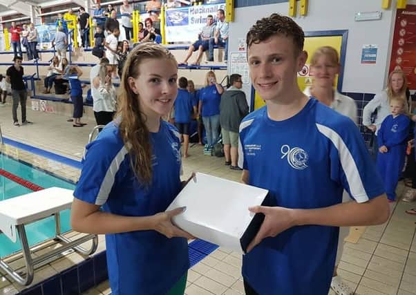 Swimmers Sophie Bunker, 17, and Liam Marsh, 16, receiving Sutton Bs champions award.