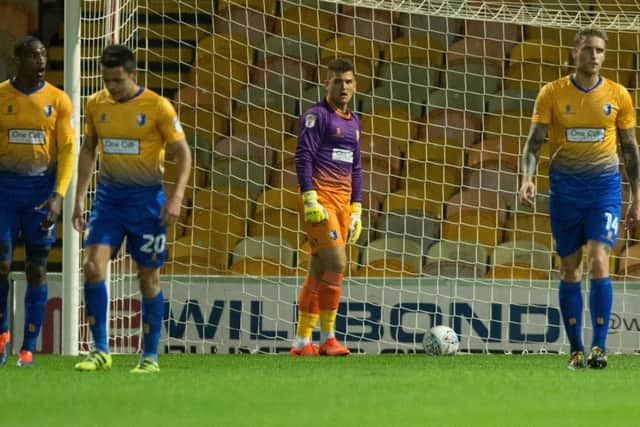 Mansfield vs Lincoln - Mansfield players regroup after Elliott Whitehouse of Lincoln City levels the scores - Pic By James Williamson