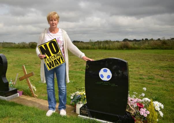 Ingrid Chapman is concerned about the effects on Oxcroft cemetery if proposed fracking goes ahead in Bolsover, Ingrid is pictured with her husbands headstone