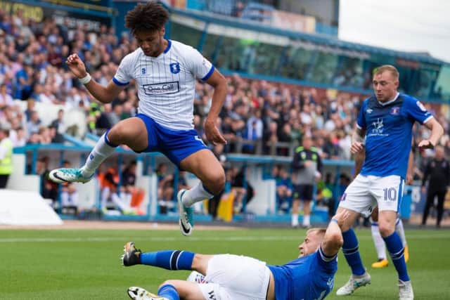Carlisle United v Mansfield Town - Lee Angol of Mansfield Town leaps over the tackle of Danny Grainger of Carlisle United - Pic By James Williamson