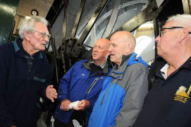 Dennis Hall, left, tells tales of his experience as a miner to visitors, Bryan Turnbull and Gordon Parkman, with Walter Edson, right, a founder of Friends of Pleasley Pit listening on.