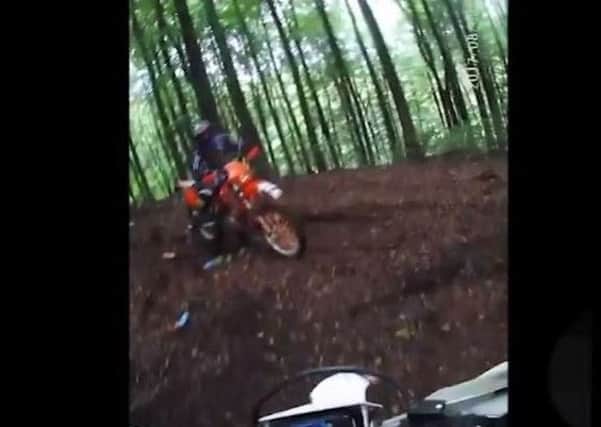 Police intercept an off-road biker in the woods. Scroll below to see video.