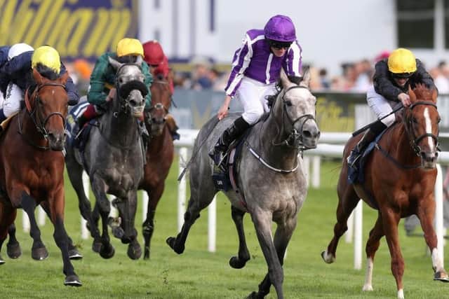 Capri, ridden by Ryan Moore, holds on to win the William Hill St Leger at Doncaster.