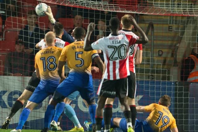 Cheltenham Town v Mansfield Town - Conrad Logan claws away a goal bound effort - Pic By James Williamson