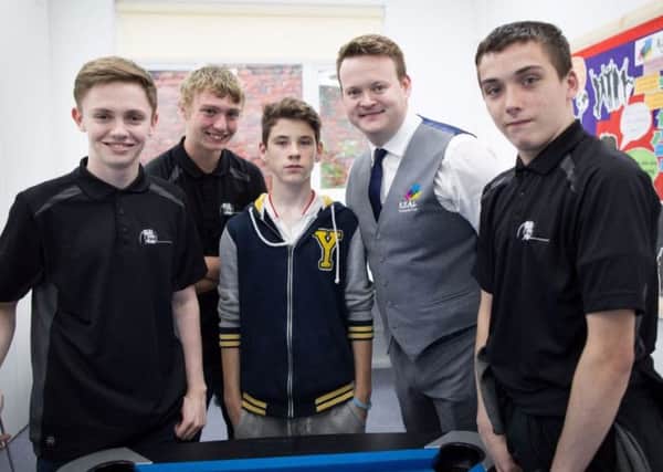 Snooker champion Shaun Murphy with R.E.A.L. Education students at a charity event last year.