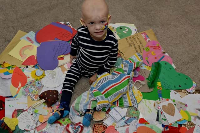 Dawson Wilcox, two pictured with hearts sent by well wishers
