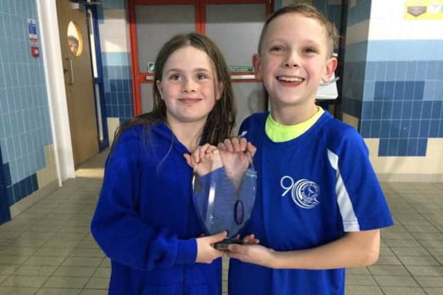 Sutton A duo Anna Woodhall and Evan Hawley with the First Division trophy.