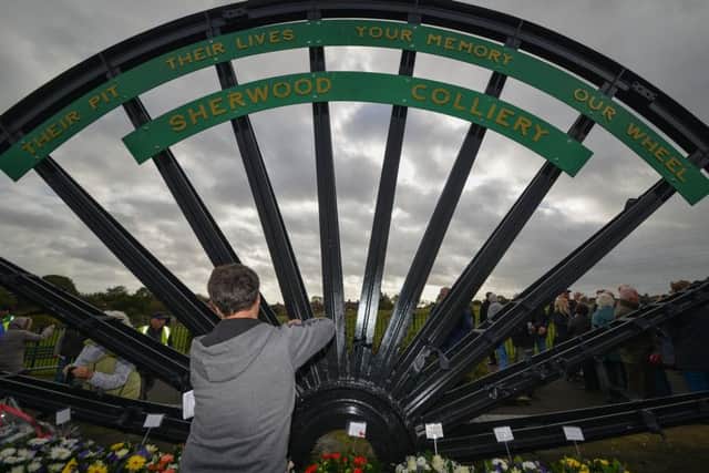 Mineworkers memorial service at the site of the Sherwood Colliery Pit Wheel, tying black ribbons on the Colliery wheel in remembrance