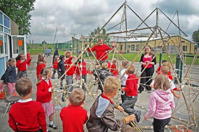 Sam McGeever, creative director at Infinite Playgrounds, encourages youngsters to develop their ideas about play equipment on an earlier project.