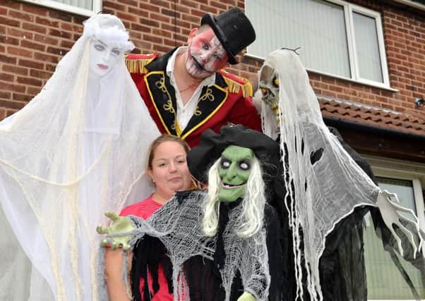 The Marriott Family are creating a haunted house for Halloween with all donations to A Dollar For Dawson, pictured is stilt walker Ryan Bowskill of Party Generators with Kirsty Marriott