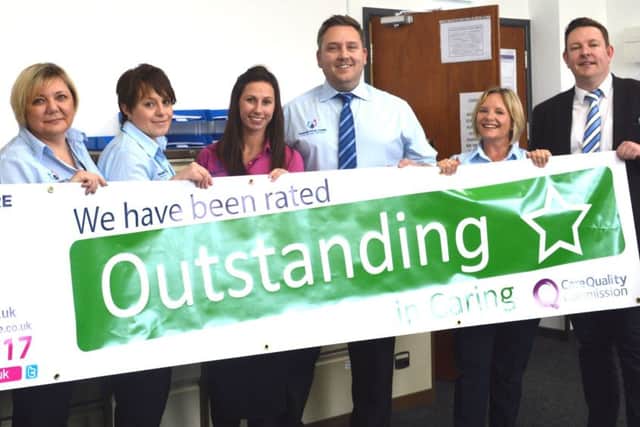 Respectful Care's co-founder Scott Marsh (right) celebrates the Outstanding rating with branch chief Karl Overton (third right) and staff.
