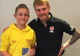 Tyler Broome (left) receiving his trophy from one of his heroes, Tom Bishop, who is ranked the worlds number seven triathlete.