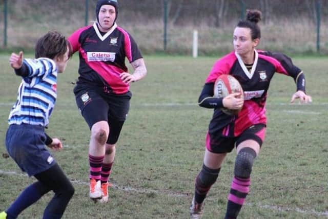 On the run against Halifax Ladies is Vicky Fegan (right), the scorer of two tries for Ashfield Ladies.