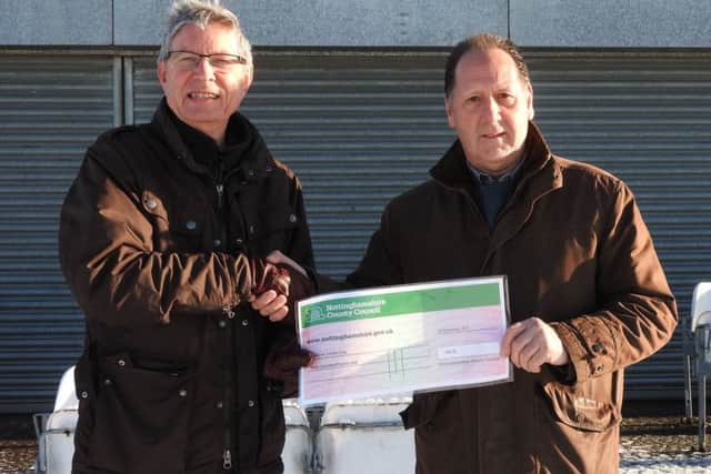 County councillor John Peck (left) presents a cheque for Â£300 to cricket club chairman Alan Hunt.