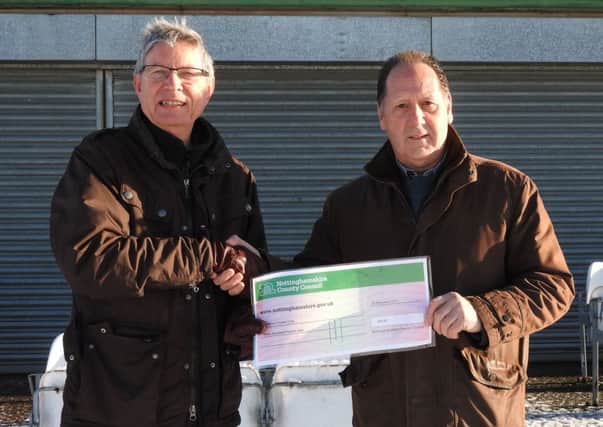 County councillor John Peck (left) presents a cheque for Â£300 to cricket club chairman Alan Hunt.