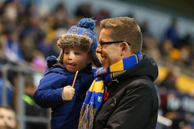 A Mansfield Town fan and his son before the game.