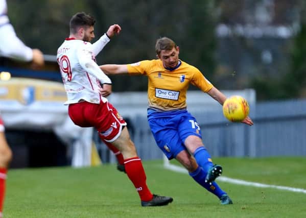 James Spencer of Mansfield Town clears the ball against Danny Newton of Stevenage during the Sky Bet League 2 match between Mansfield Town and Stevenage at the One Call Stadium, Mansfield, England on 18 November 2017. Photo by Leila Coker / PRiME Media Images.