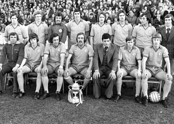 Mansfield Town's Division Three Championship presentation in 1977.   Left to right. Back row; I. McDonald, I. Wood, R. Arnold, E. Moss, K. Bird, I. McKenzie, C. Foster and B. Foster. Front row; G. Clarke, R. Cooke, K. Randall, G. Hodgsom, P. Morris. P. Matthews and B. McEwan.