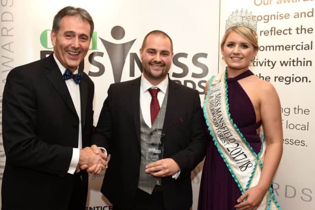 Sean O'Connor, of O'Connor & Co Removals, centre, receives his business of the year award from Gev Lynott, chief executive of award sponsor Mansfield Building Society, with awards special guest Miss Mansfield & Sherwood Forest Jessica Pinnick. Pictures: Andrew Roe.