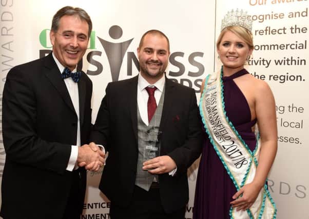 Sean O'Connor, of O'Connor & Co Removals, centre, receives his business of the year award from Gev Lynott, chief executive of award sponsor Mansfield Building Society, with awards special guest Miss Mansfield & Sherwood Forest Jessica Pinnick. Pictures: Andrew Roe.