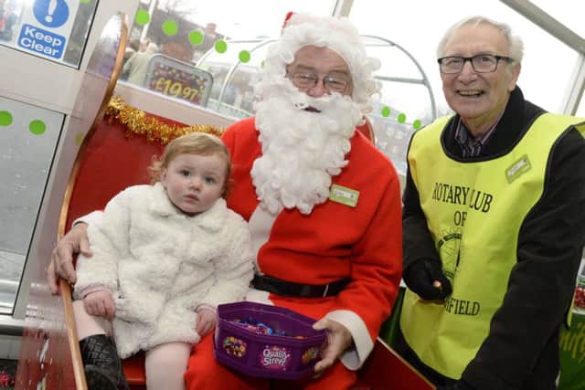 Sutton Rotary Club were raising money at Asda in Sutton. Phil Bustin,right, with Santa and Summer-Louise Prudence,one