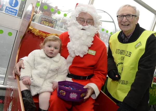 Sutton Rotary Club were raising money at Asda in Sutton. Phil Bustin,right, with Santa and Summer-Louise Prudence,one