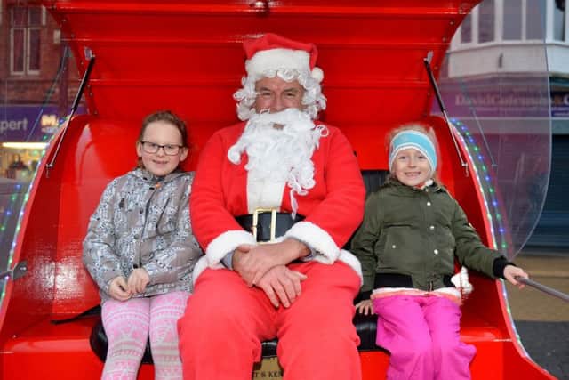 Sutton In Ashfield Christmas lights switch on, Jazmyne Jayne Harrod, seven and friend Dakota-Zia Fletcher, six meeting Santa