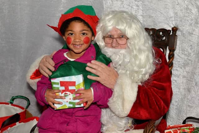 Sutton In Ashfield Christmas lights switch on, pictured is six-year-old Sapphire Sima with Santa