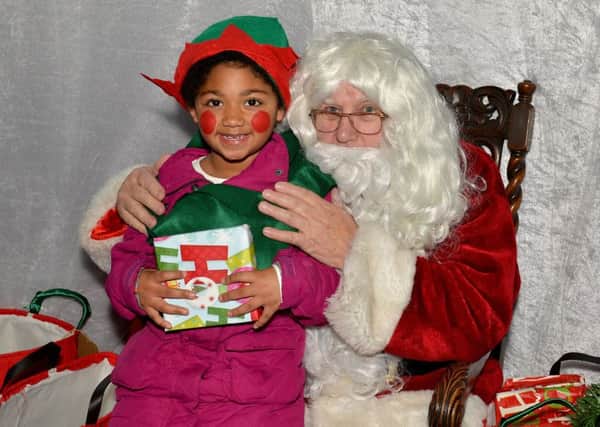 Sutton In Ashfield Christmas lights switch on, pictured is six-year-old Sapphire Sima with Santa