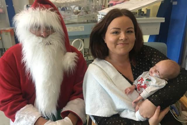 Cara Morphus and baby George meet Santa at King's Mill Hospital
