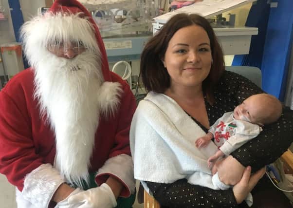 Cara Morphus and baby George meet Santa at King's Mill Hospital