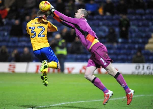Mansfield Town v Morcombe
Danny Rose has the ball pinched off his head by Morcambe 'keeper Barry Roche.