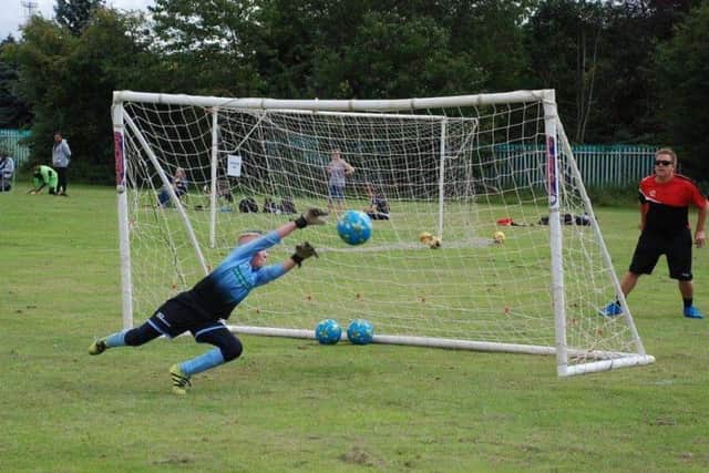 At full stretch is one of the young goalkeepers at the AC1 academy.