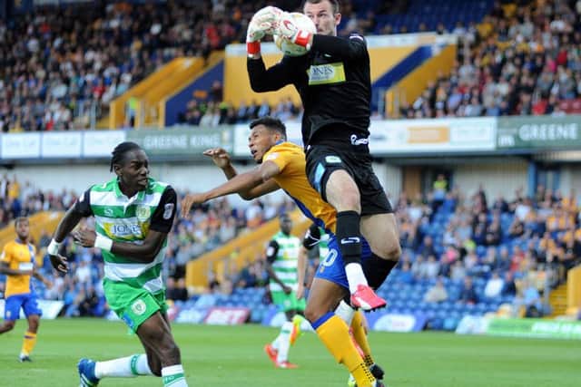 Mansfield Town v Yeovil Town.    Matt Green and Yeovil's Nathan Smith are beaten to the ball by 'keeper ArturKrysiak.