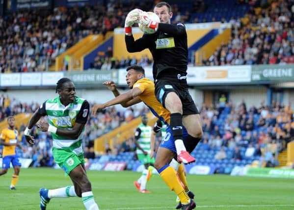 Mansfield Town v Yeovil Town.    
Matt Green and Yeovil's Nathan Smith are beaten to the ball by 'keeper ArturKrysiak.