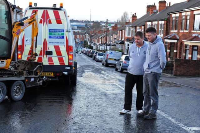 Stella Street residents, Alan Edson and Ben Perry who were concerned that water from a broken pipe would turn to ice.