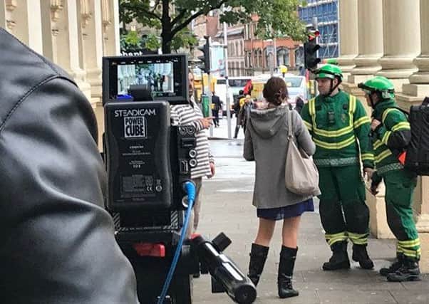 Paramedics helping to film a scene for the video near the Theatre Royal in Nottingham.