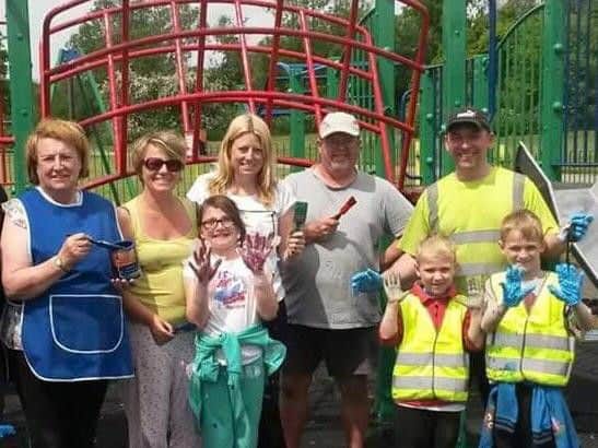 Volunteers painting the old park two years ago.