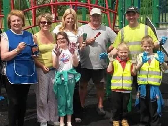 Volunteers painting the old play park two years ago.