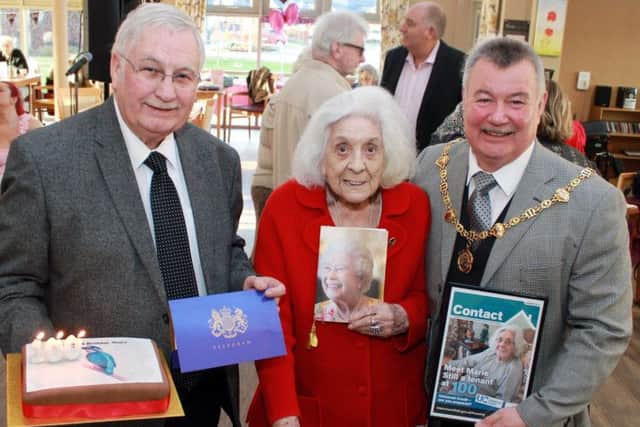Marie Rowley the oldest resident at Poppy Fields Extra Care sheltered housing complex, Marie celebrated reaching her centenary with a surprise party on 17 January. Left to right: Mansfield District Council Portfolio Holder for Housing, Cllr Barry Answer, with Marie's telegram from Esther McVey, Secretary of State for Work and Pensions; Marie Rowley, holding her card from the Queen; Cllr Kevin Brown, Chairman of Mansfield District Council, holding a framed front cover of Contact magazine for council tenants