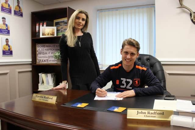 Danny Rose signs his contract extension watched by club CEO Carolyn Radford.