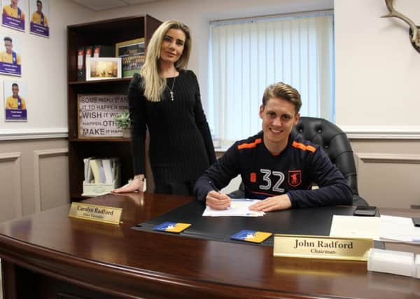 Danny Rose signs his contract extension watched by club CEO Carolyn Radford.