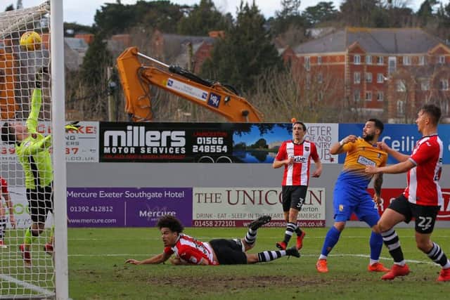 Mansfield's Kane Hemmings hits the Exeter bar before Danny Rose volleys home the rebound.