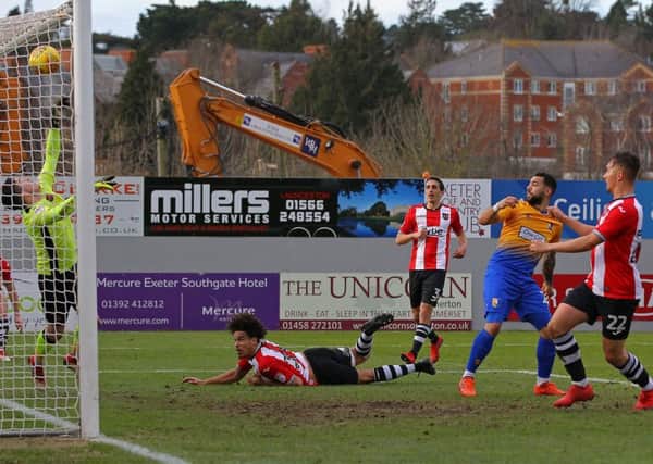 Mansfield's Kane Hemmings hits the Exeter bar before Danny Rose volleys home the rebound.