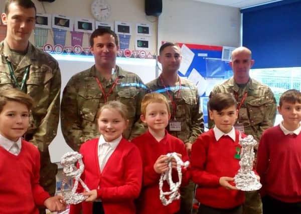 Soldiers from the Royal Engineers with five of the youngsters at Berry Hill Primary School in Mansfield. (PHOTO BY: Corinna Brown)