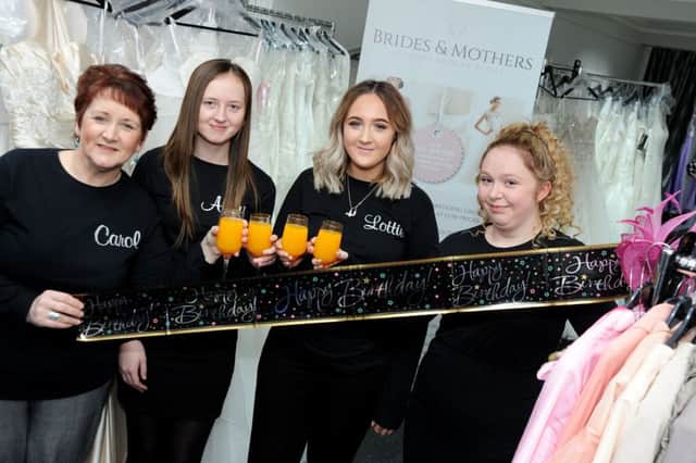 Staff at the Brides and Mothers Designer Wedding Outlet from left, manager Carol Warriner, Abby Cotterill, Lottie Hume and Bethany Warriner toast their first anniversary in business at the Ransom Wood Business Park.