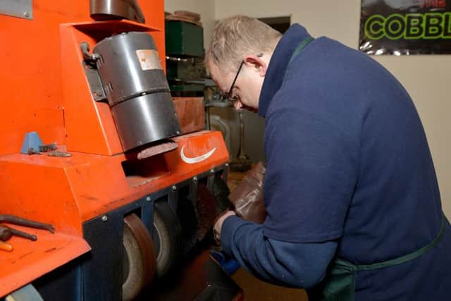 Shoe repairer David Lee hard at work in his new shop on Outram Street, Sutton-In-Ashfield