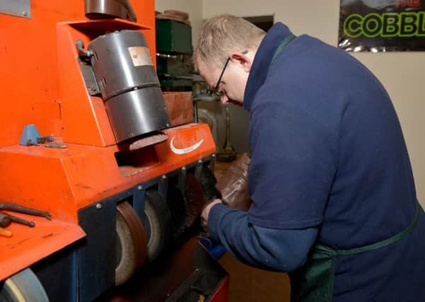 Shoe repairer David Lee hard at work in his new shop on Outram Street, Sutton-In-Ashfield