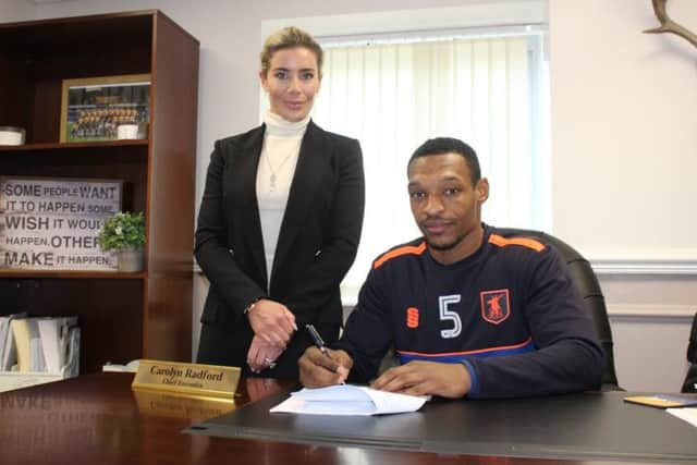 Krystian Pearce signs his new deal today watched by club CEO Carolyn Radford.
