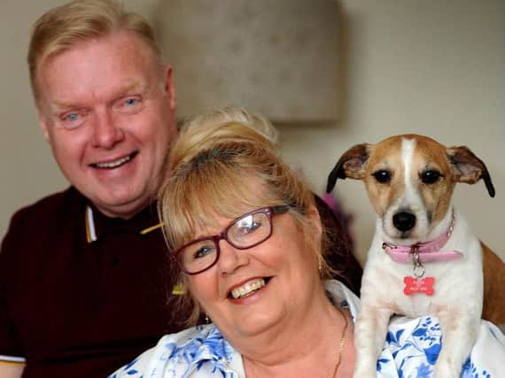 Angela Yates of Clipstone who is on an ITV singing show, with husband Mick and dogs Hollie and Casper.